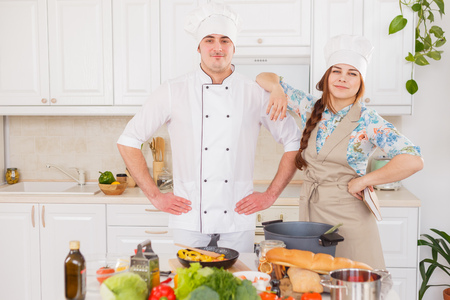 Chef and his student cook in the kitchenの写真素材