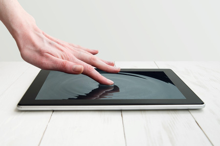 human hand touching futuristic screen.の写真素材