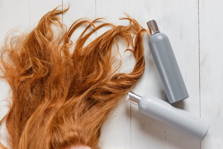 Two shampoo bottles for hair ginger bright colour top view, copy space. Beautiful hair care conceptの写真素材