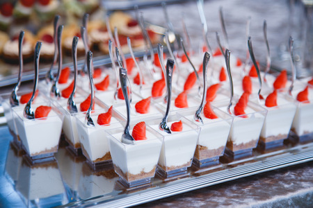 Portion cups with strawberries and cream for a buffet tableの写真素材