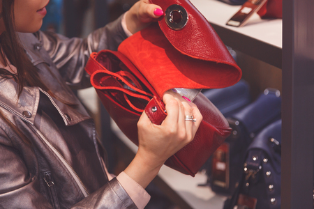 Female customer purchasing new handbag in shopの写真素材