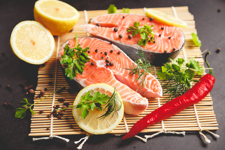 Salmon steaks with lemon and spices close up view.の写真素材