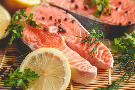 Salmon steaks with lemon and spices close up view.の写真素材