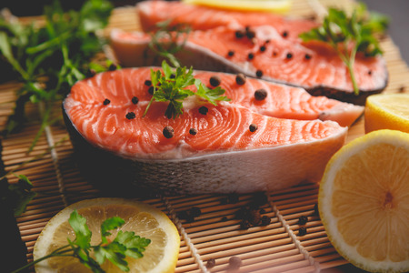 Salmon steaks with lemon and spices close up view.の写真素材