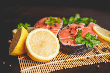 Salmon steaks with lemon and spices close up view.の写真素材