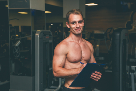Personal Trainer, with a pad in his handの写真素材