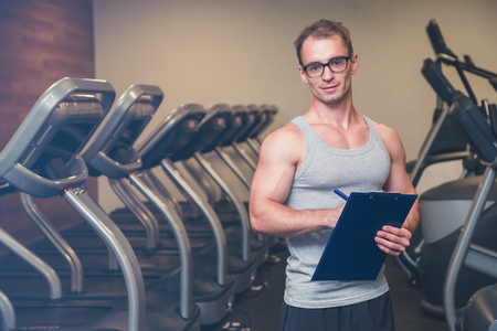 Woman working out in a gym with her personal trainerの写真素材