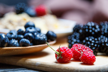 Berries mix blueberry, raspberry on rustic wooden tableの写真素材