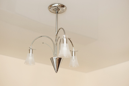 Modern ceiling lamp in the room made of glass and metalの写真素材