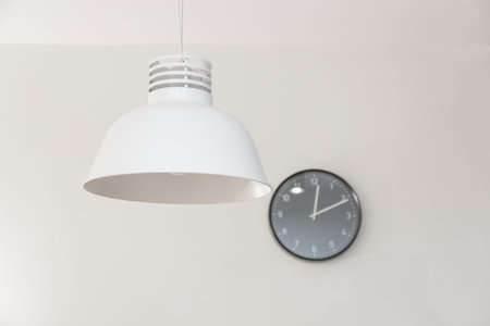 Stylish lamp and clock on wall.の写真素材