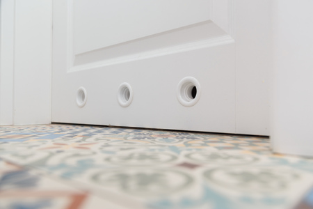 Bathroom door with holes for ventilationの写真素材
