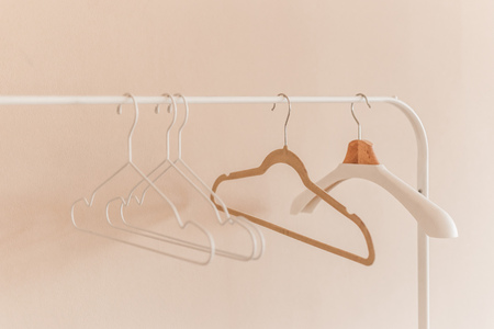 wooden coat hangers on clothes rail.の写真素材