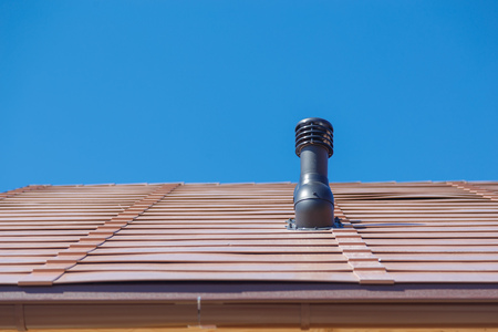 Chimney pipe on the roof of the house.の写真素材