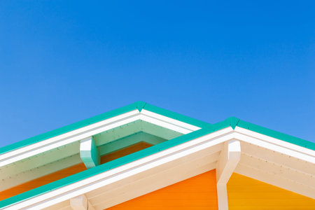 Colourful rooftops on blue sky background.