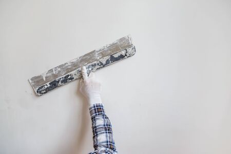Putty the wall gypsum putty with spatulasの写真素材