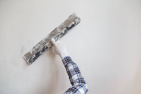 Putty the wall gypsum putty with spatulasの写真素材