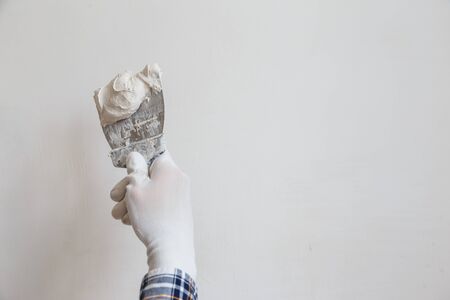 Putty the wall gypsum putty with spatulasの写真素材