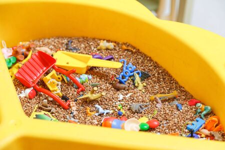 Kids toys and buckwheat for development of fine motor conceptの写真素材