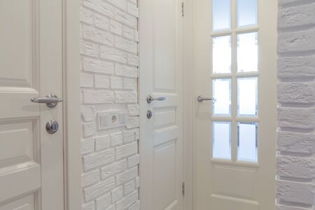White classic doors and white decorative brick wall.の写真素材
