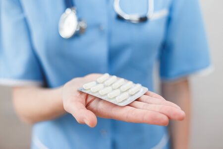 Doctor holds a blister with an antibiotic.の写真素材