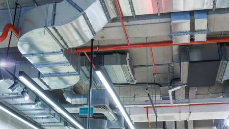 Industrial utilities under the ceiling. Ventilation, air conditioning, lighting and fire fightingの写真素材