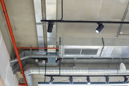 Industrial utilities under the ceiling. Ventilation, air conditioning, lighting and fire fightingの写真素材