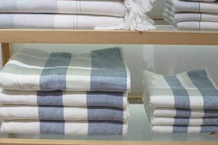 Shelves with towels stacks in shop. Hygge or another scandinavian styleの写真素材