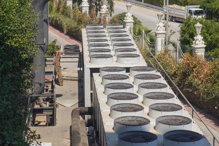 Overview of multiple air conditioning units on a roof topの写真素材