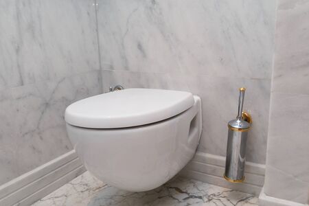Hanging on wall white toilet bowl, grey natural marble.の写真素材