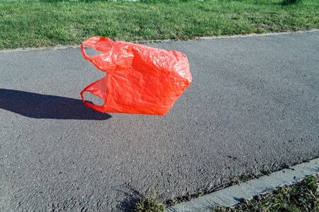 Pollution concept. Plastic bag, flying in the wind in the street.の写真素材