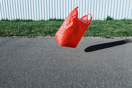 Pollution concept. Plastic bag, flying in the wind in the streetの写真素材