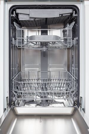 Empty new dishwasher with open doorの写真素材