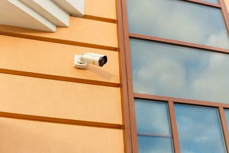 Outdoor surveillance camera on the facade of the building. The concept of safety, security and law and orderの写真素材