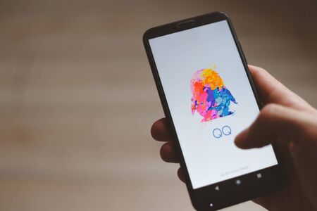 Minsk, Belarus - November 06, 2019: Tencent QQ application on smartphone. The most popular messenger in Chinaのeditorial素材