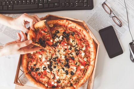 Business Lunch delivered to the workplace. Vegetarian pizza sharingの写真素材