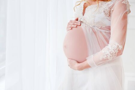 Close up of a cute pregnant belly.の写真素材
