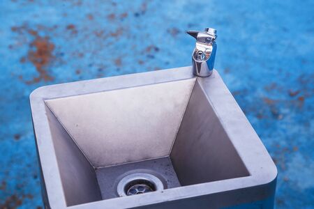 Modern drinking water tap with metal sink outdoor.の写真素材