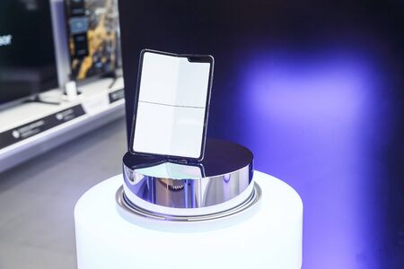Minsk, Belarus - December 25, 2019: Viewing the new Samsung Galaxy Fold 5G. Folding touch screen smartphone on presentation stand in the window of the showroomのeditorial素材