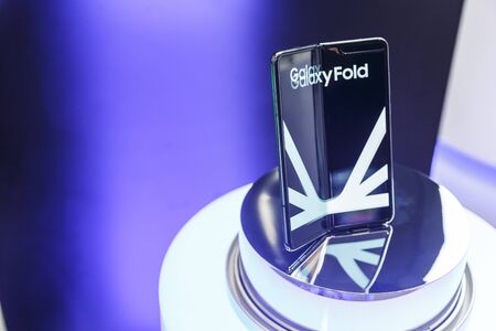 Minsk, Belarus - December 25, 2019: Viewing the new Samsung Galaxy Fold 5G. Folding touch screen smartphone on presentation stand in the showcase of the showroomのeditorial素材