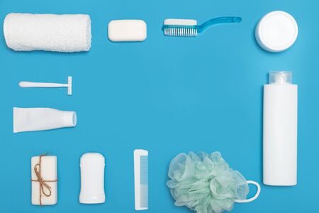Body and skin hygienic care toiletry products, in white packaging on a blue water concept background. Personal hygiene products. Flat lay, top view on blue backgroundの写真素材