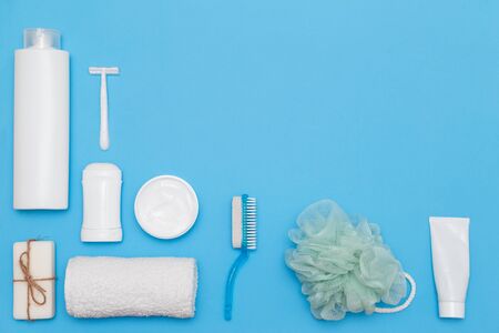 Body and skin hygienic care toiletry products, in white packaging on a blue water concept background. Personal hygiene products. Flat lay, top view on blue backgroundの写真素材