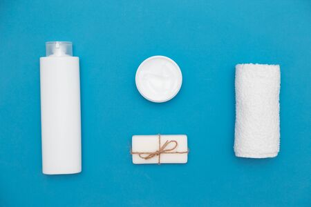 Body and skin hygienic care toiletry products, in white packaging on a blue water concept background. Personal hygiene products. Flat lay, top view on blue backgroundの写真素材