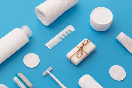 Body and skin hygienic care toiletry products, in white packaging on a blue water concept background. Personal hygiene products. Flat lay, top view on blue backgroundの写真素材