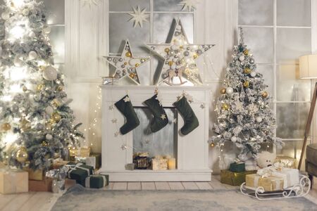 Christmas stocking hanging from a mantel or fireplace, decorated for Christmas with fire glowing.の写真素材