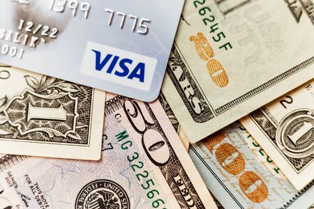 Minsk, Belarus - January 3, 2019: Photo of VISA system plastic card with american dollars.のeditorial素材