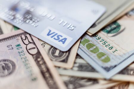 Minsk, Belarus - January 3, 2019: Photo of VISA system plastic card with american dollars.のeditorial素材