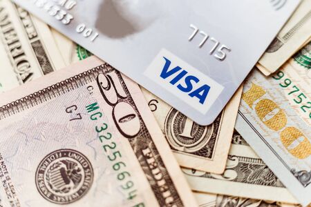 Minsk, Belarus - January 3, 2019: Photo of VISA system plastic card with american dollars.のeditorial素材