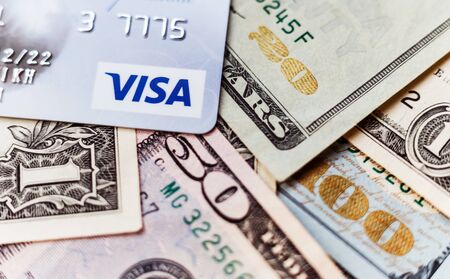 Minsk, Belarus - January 3, 2019: Photo of VISA system plastic card with american dollars.のeditorial素材