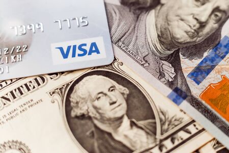 Minsk, Belarus - January 3, 2019: Close-up of visa card on dollar bill background.のeditorial素材