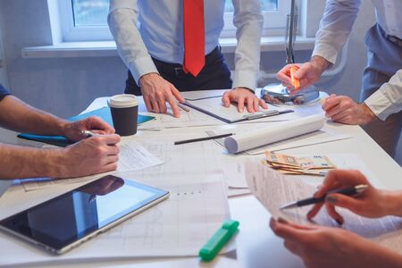 Image of business team sitting at the table and discussing a new projectの写真素材